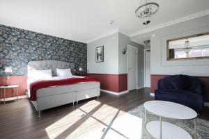 a bedroom with a bed and a chair and a table at Hotell Arkad in Västerås