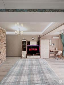 a living room with a tv and a table at RentHouse Apartments Elegant in Chişinău