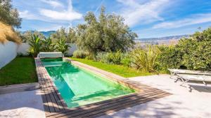 a swimming pool in the backyard of a house at Molino del Azahar El Valle by Ruralidays in Melegis