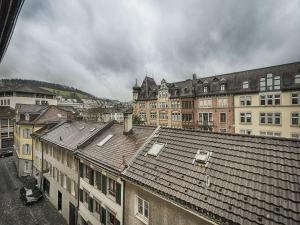 an overhead view of a city with buildings and roofs at Hotel Weisses Kreuz in St. Gallen
