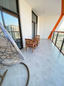 a balcony with two chairs and a table in a building at Downtown Dubai 7 minutes away from Burj Khalifa in Dubai