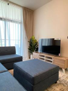 a living room with a couch and a flat screen tv at Downtown Dubai 7 minutes away from Burj Khalifa in Dubai