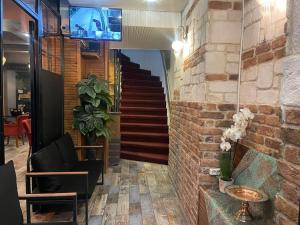 a lobby with a staircase and a brick wall at AYSA Hotel in Istanbul