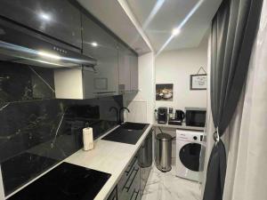 una cocina con encimera en blanco y negro en Cozy Rental SPA, en Schiltigheim