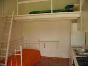 Łóżko lub łóżka piętrowe w pokoju w obiekcie Casine degli Ulivi