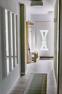 a hallway with a room with white walls and a rug at Ferienwohnung Waldfeeling in Brilon