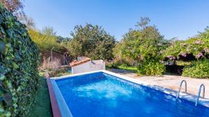 a swimming pool in the yard of a house at Parajes del Chanza Cortegana by Ruralidays in Cortegana