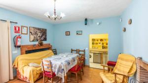 a bedroom with blue walls and a table and chairs at Parajes del Chanza Cortegana by Ruralidays in Cortegana