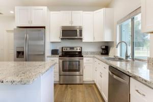 a kitchen with white cabinets and stainless steel appliances at Two Bedroom guest house in Gilbert in Gilbert