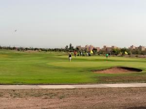 a group of people playing golf on a golf course at Marrakech Villa du Golfeur familles uniquement in Marrakesh