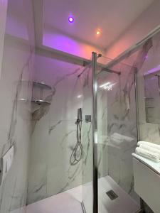 a bathroom with a shower with a glass at Cuore D'aMare B&B in Bari