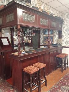 a bar in a pub with two stools at Bianca Guesthouse in Blackpool