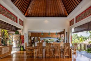 a dining room with a table and chairs at Villa Lembah Damai by Pramana Villas in Gianyar