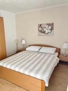 a bedroom with a large bed with two night stands at Apartment Araucaria in Crikvenica