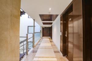a hallway with a door and a stairway at FabHotel Grand Stay in New Delhi