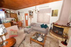 a living room with a couch and a fireplace at Villa Makrades Deluxe in Makrádes