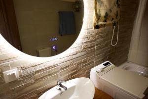 a bathroom with a sink and a mirror and a toilet at Villa Makrades Deluxe in Makrádes +16 photos