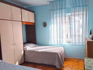 a small bedroom with a bed and a window at Apartment Danica 356 in Umag