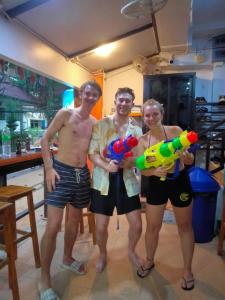 a group of three people posing for a picture at Voyagers Hostel in Phi Phi Islands