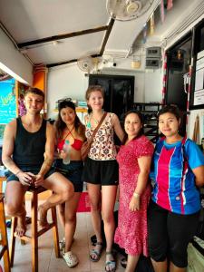 a group of women posing for a picture in a food truck at Voyagers Hostel in Phi Phi Islands