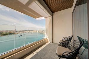 a balcony with chairs and a view of the water at Land's End, Boutique Hotel in Sliema