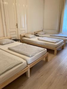a group of four beds in a room at Gogol24 in Szeged