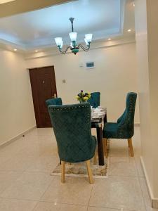 a dining room with a table and chairs at Luxurious 2bedroom furnished apartment in Nairobi