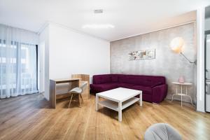 a living room with a purple couch and a table at Luxury Pipera in Voluntari +230 photos