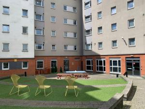 a patio with a table and chairs in front of a building at Ensuite Bedrooms with Shared Kitchen and Studios at The Heights in Birmingham in Birmingham