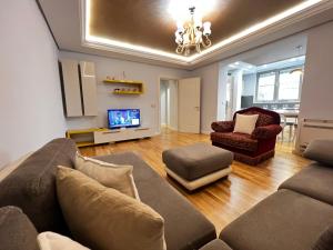 a living room with a couch and a tv at Tirana center in Tirana