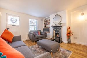 a living room with a couch and a fireplace at Eden Cottage in Wells next the Sea