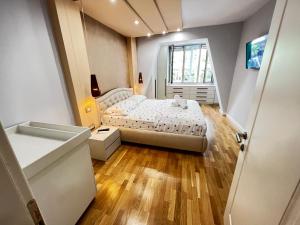 a small bedroom with a bed and a window at Tirana center in Tirana