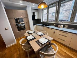 a kitchen with a table and chairs in a room at Tirana center in Tirana