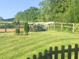 einen Zaun vor einem Feld mit einer Bank in der Unterkunft Carrot Cottage - Uk32609 in Manton