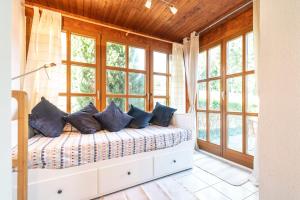 a bedroom with a bed with blue pillows on it at Ackerweg Ferienwohnungen in Ueckeritz