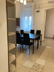 a dining room with a black table and black chairs at Gogol24 in Szeged