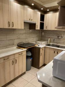 a kitchen with wooden cabinets and a sink and a counter at Gogol24 in Szeged