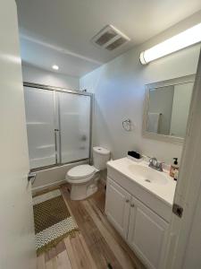 a bathroom with a toilet and a sink and a shower at Hollywood Loft Modern Style 1 Bedroom in Los Angeles