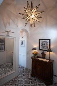 a room with a lamp, a rug, and a clock on the wall at Affittacamere Capri Dolce Vita in Capri