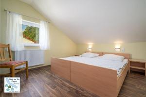 a bedroom with a large bed and a window at Wald und See Dargun 16A in Dargun