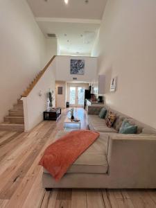 a living room with a couch and a staircase at Hollywood Loft Modern Style 1 Bedroom in Los Angeles