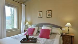 a bedroom with a bed with pillows and a window at Il Mirto in Gavorrano +36 photos