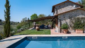 a house with a swimming pool in a yard at Casa Perano in Gaiole in Chianti
