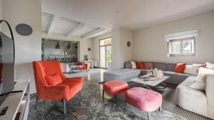 a living room with a couch and chairs at Casale San Vincenti in Gaiole in Chianti