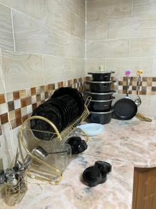 a kitchen counter with a bunch of dishes on it at Jasmine's House in Jerash