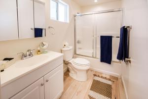 a bathroom with a toilet and a sink and a shower at Hollywood Sign View in Modern 1 Bedroom Loft in Los Angeles