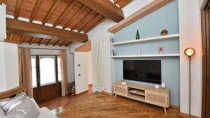 a living room with a flat screen tv on a wall at Podere La Casa in Cavriglia