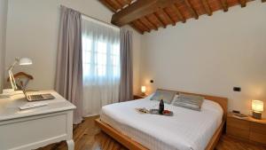 a bedroom with a bed and a laptop on a desk at Podere La Casa in Cavriglia +17 photos