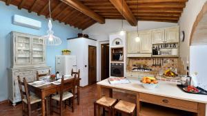 a kitchen with a table and some chairs in a room at Podere La Casa in Cavriglia