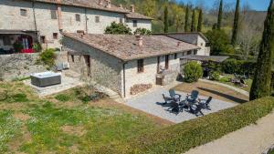 an aerial view of a house with chairs in the yard at La Porcilaia in Castelnuovo Berardenga